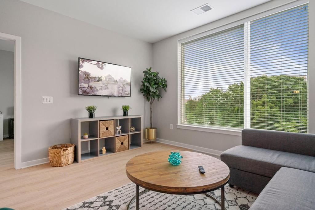 a living room with a couch and a table at Cityscape Haven Views Close to DC in Arlington