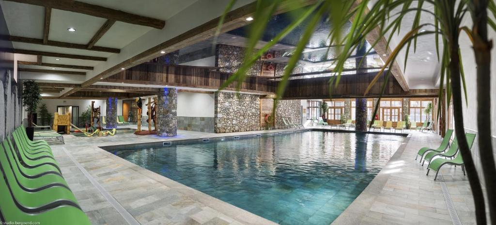 a large swimming pool in a building at CGH Résidences & Spas Kalinda in Tignes