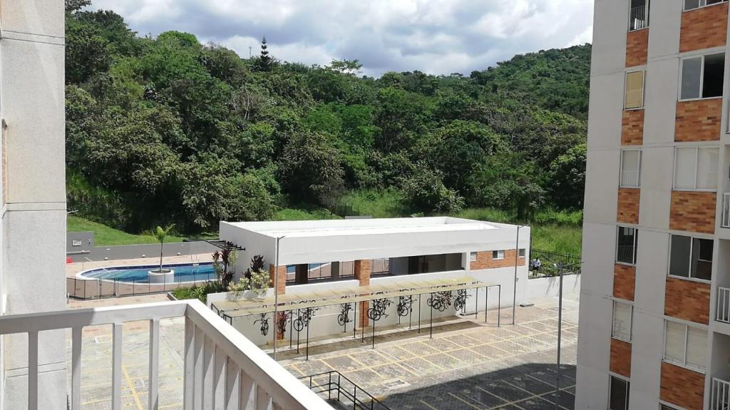 a view from the balcony of a building with a pool at Apartamento Nativa Tropical in Villeta