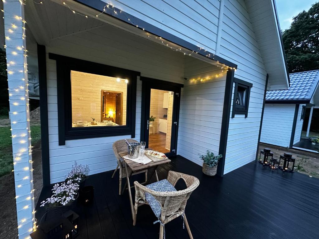 Outdoor patio with wicker chairs and string lights.