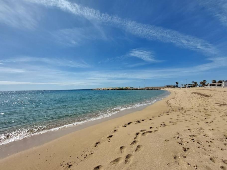 una playa con huellas en la arena y el océano en apartment Grace, just 200 meter from beach, Campomarino Madonnina, en Torre Ovo