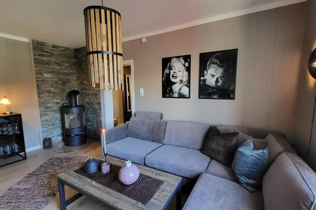 a living room with a couch and a table at Midt i Drammen - supersentralt og gratis parkering in Drammen