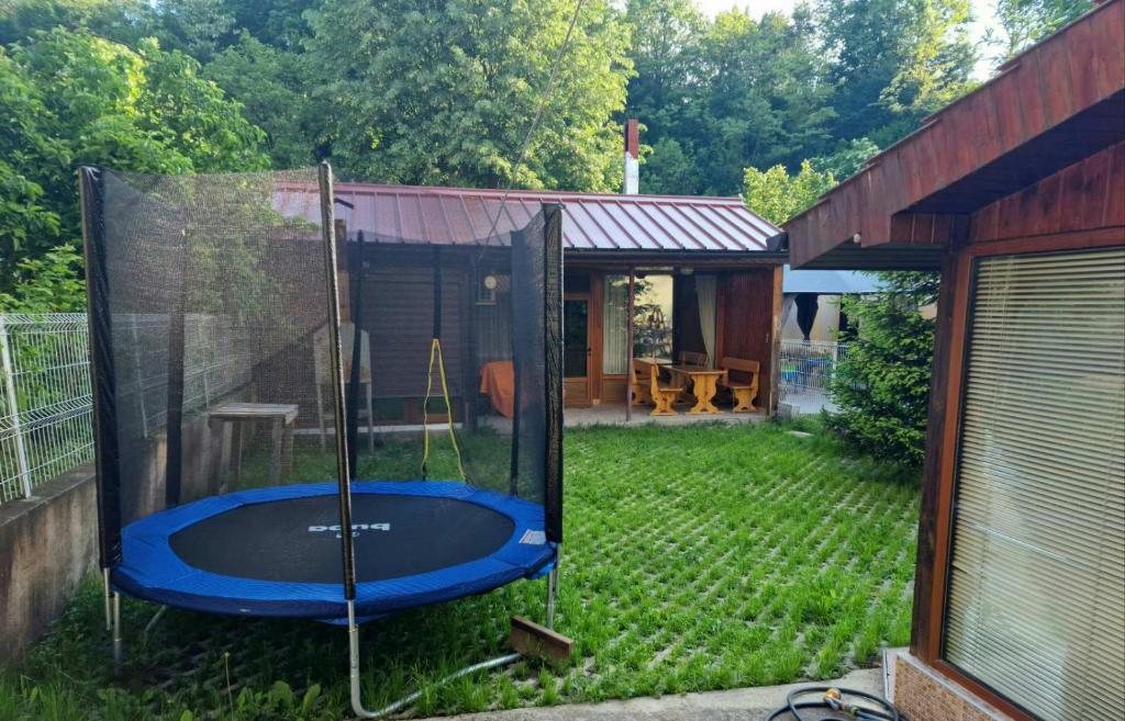 a backyard with a trampoline in the yard at Rebeka Guest House in Tryavna