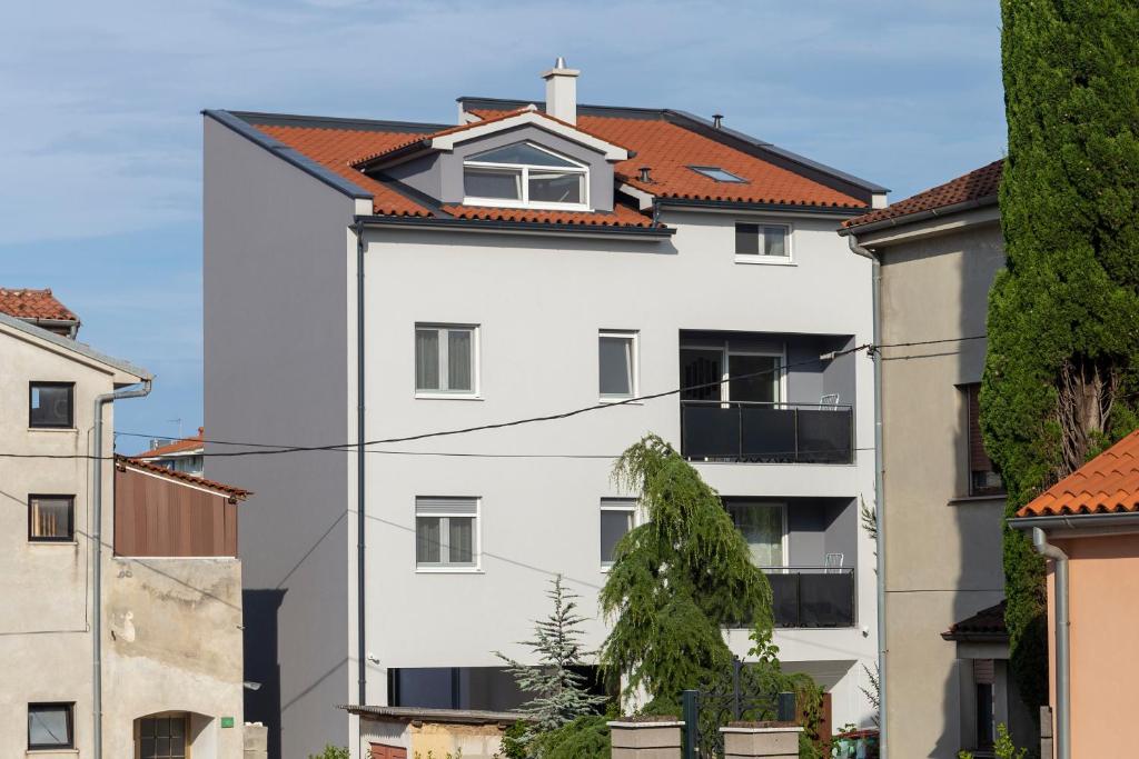 a white building with a red roof at City apartments SILVER in Pula