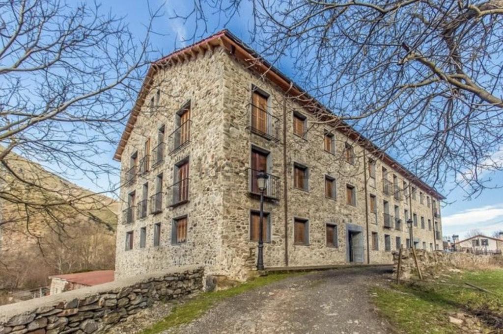 un ancien bâtiment en pierre avec un mur en pierre dans l'établissement Prime Loft LA RIOJA, à Azarrulla