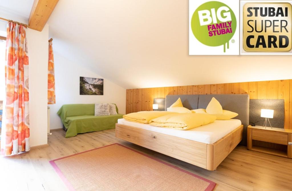 a bedroom with a large bed with yellow pillows at Haus Mary in Neustift im Stubaital