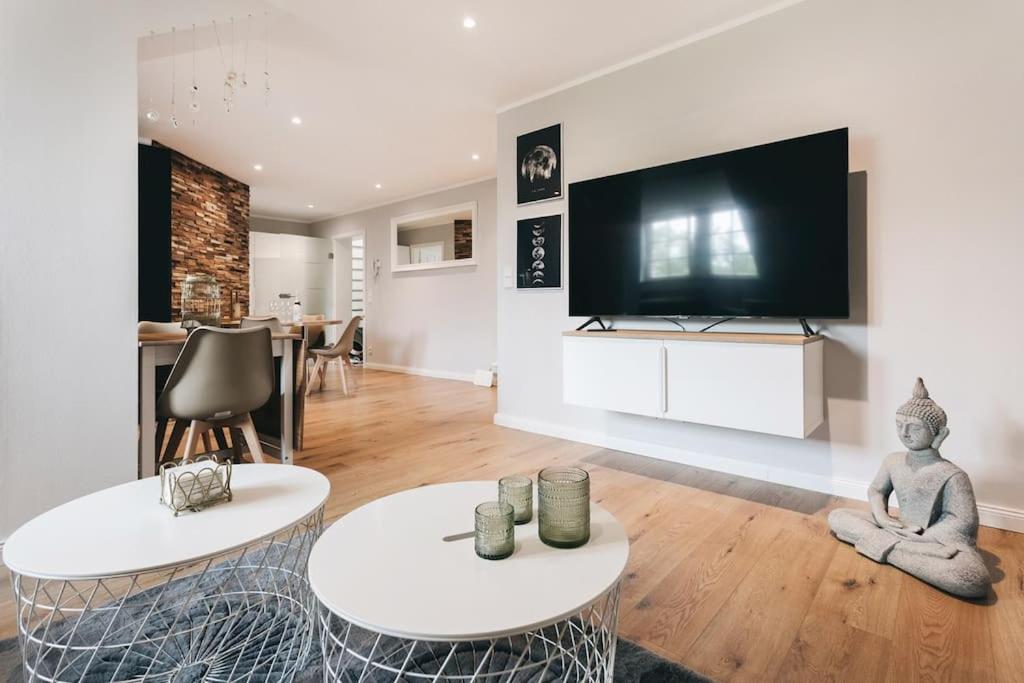 a living room with two tables and a flat screen tv at TIP! Toplage in Dresden! Moderne 100 qm Ferienwohnung für Familien und kleine Gruppen in Dresden