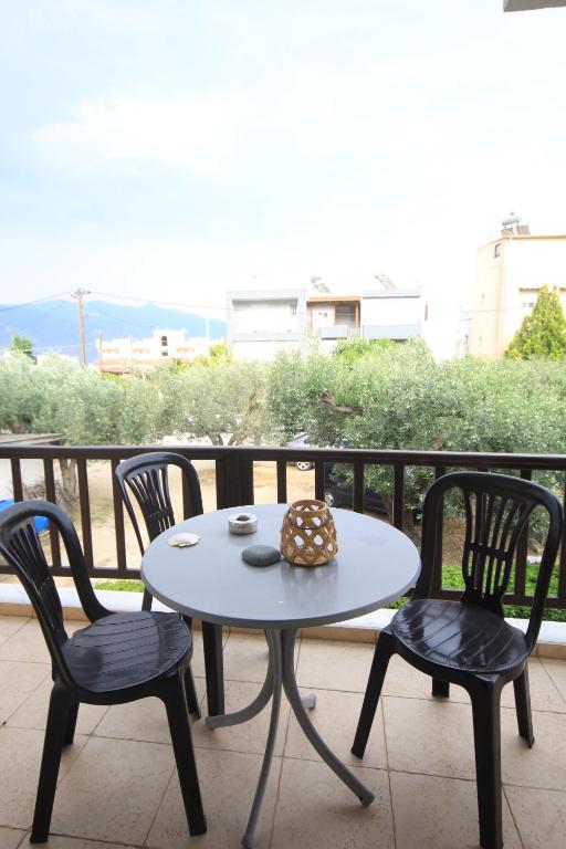 a table and chairs on a balcony with a view at Maria's house Alykes in Kritharia