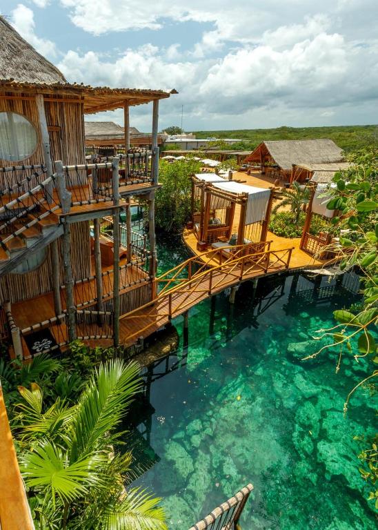 a deck in the water at a resort at Hotel Shibari - Restaurant & Cenote Club in Tulum