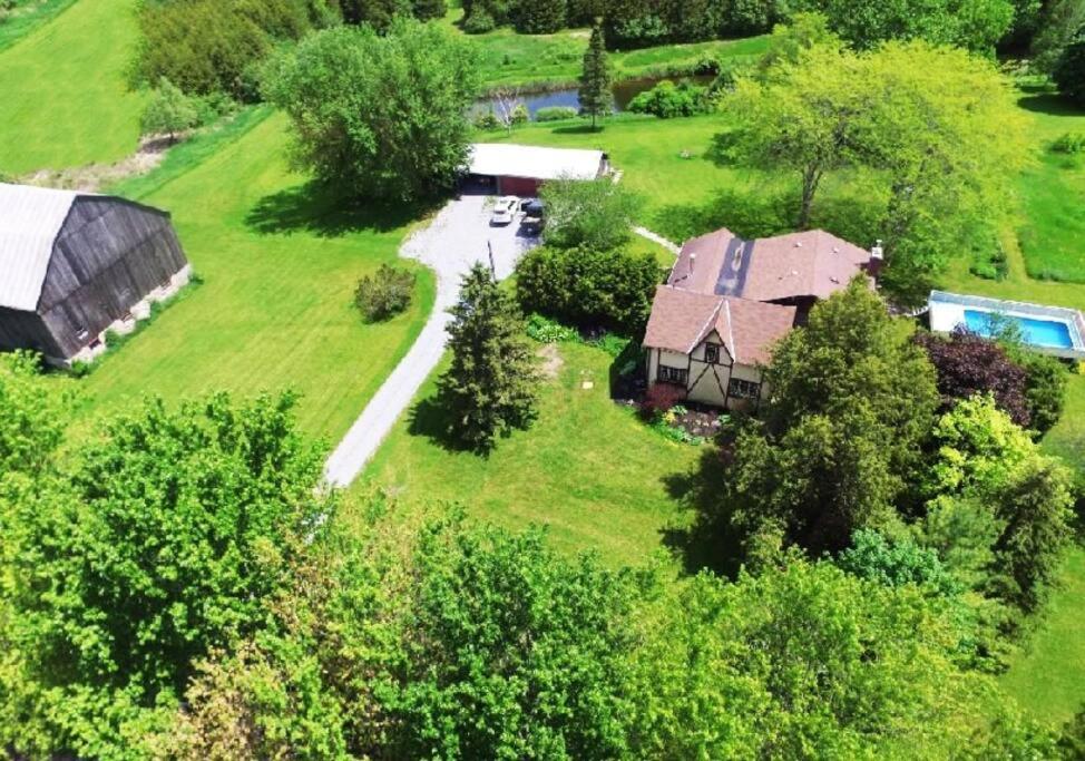an aerial view of a house in a field at Hidden Farm Escape in the Heart of Kawarthas in Beaverton