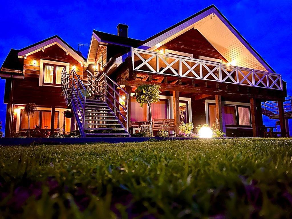 a house with a staircase in the yard at night at Przy Rozlewisku in Sarbinowo