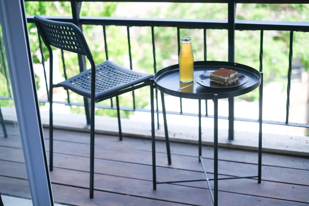 a table with a bottle of beer and a piece of cake at LevonTLV in Tel Aviv