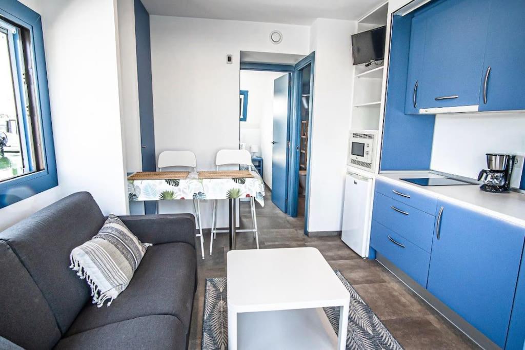 a living room with a couch and a kitchen at Apartamento flotante. Unico in Santander