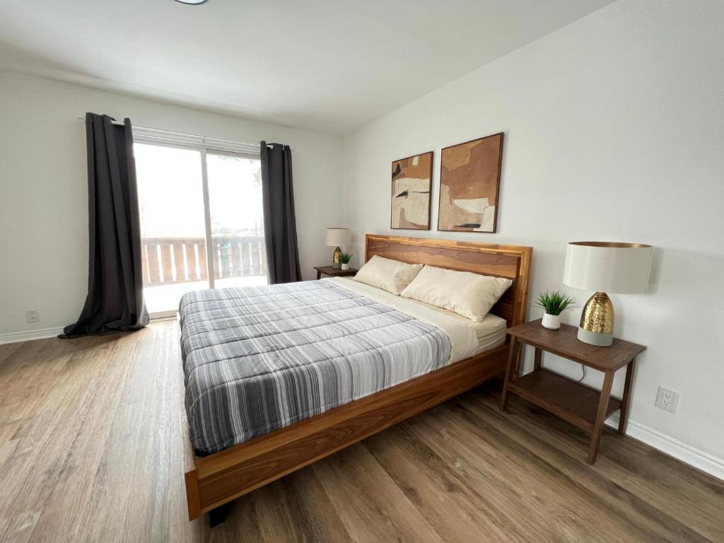 um quarto com uma cama e uma grande janela em Letitia Heights !E Spacious and Quiet Private Bedroom with Private Bathroom em Barrie