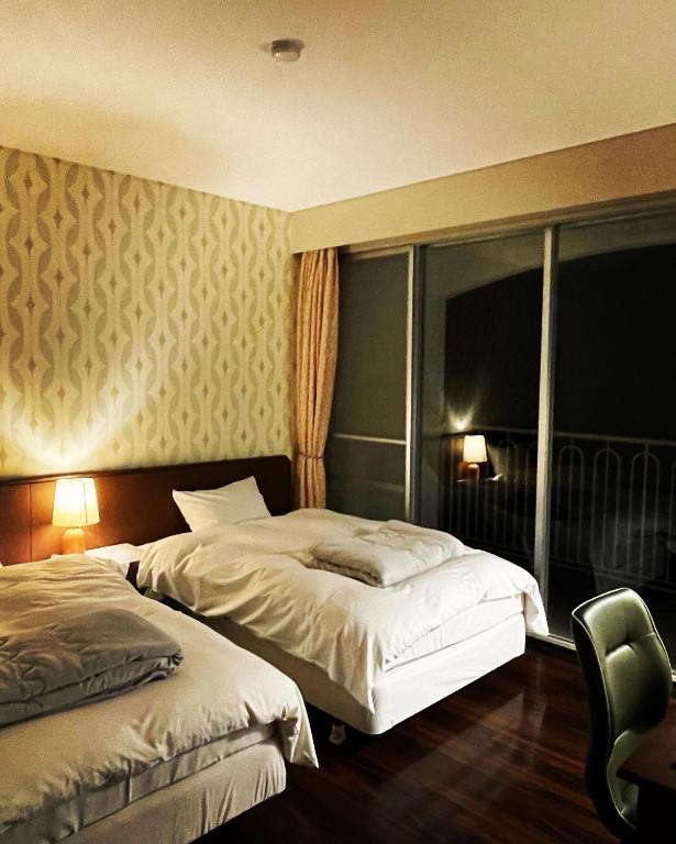 Postel nebo postele na pokoji v ubytování B&B Retreat志摩