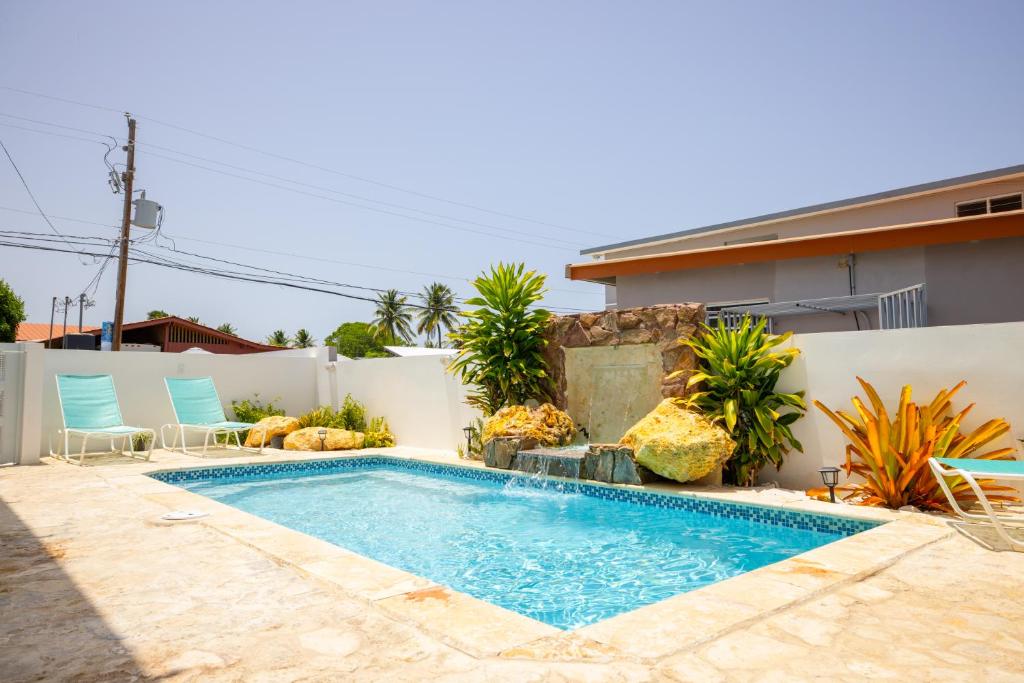 a swimming pool in the backyard of a house at R&V Combate Beach House, 2nd Floor with Pool in Cabo Rojo