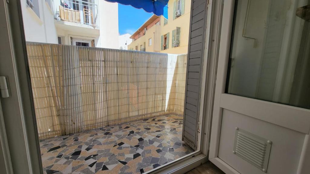 a door to a balcony with a tile floor at New two bedroom apartment with AC by the sea in Nice