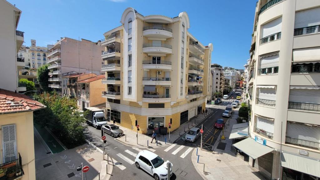 an apartment building with a white van parked in front of it at New two bedroom apartment with AC by the sea in Nice