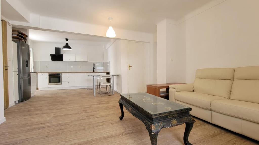 a living room with a couch and a coffee table at New two bedroom apartment with AC by the sea in Nice