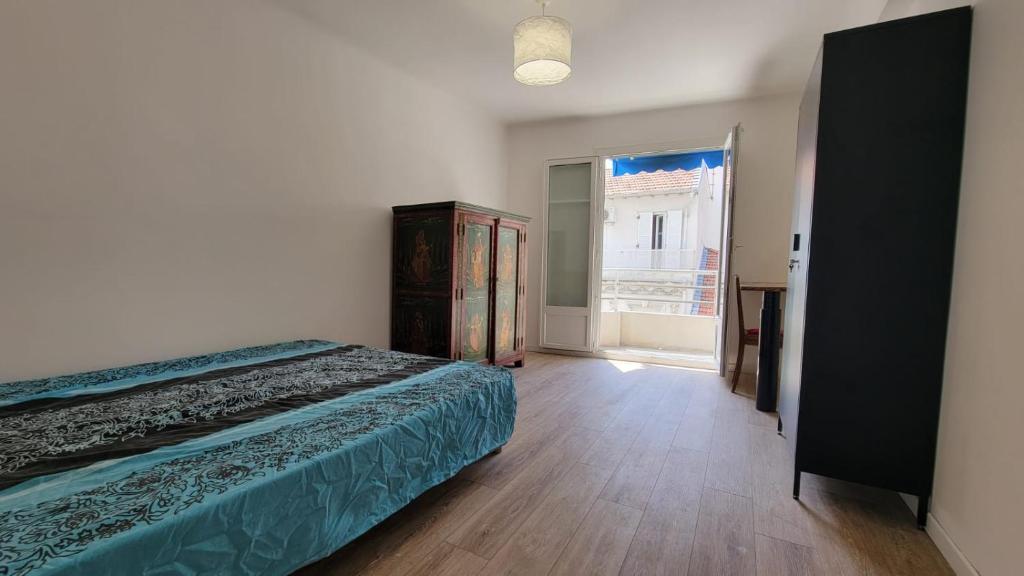 a bedroom with a bed and a large window at New two bedroom apartment with AC by the sea in Nice