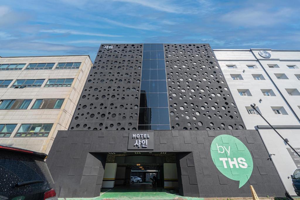 a building with a clock on the front of it at BY THS Shine Hotel Incheon in Siheung