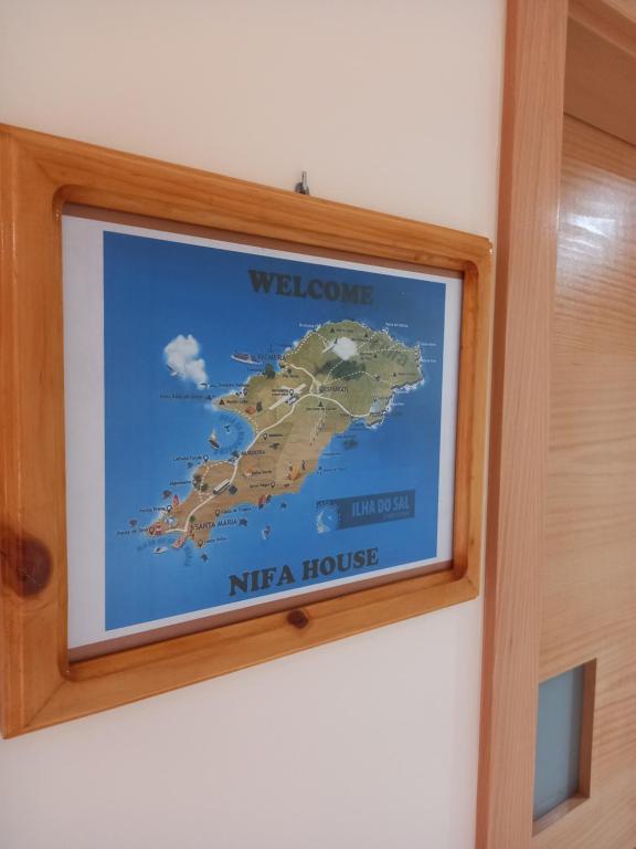 a picture of a welcome to nirra house on a wall at Nifa House in Espargos