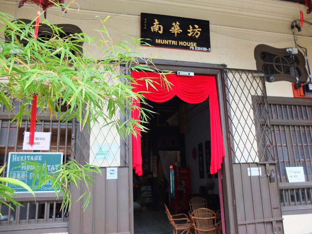 a restaurant with a red curtain over the door at Muntri House in George Town