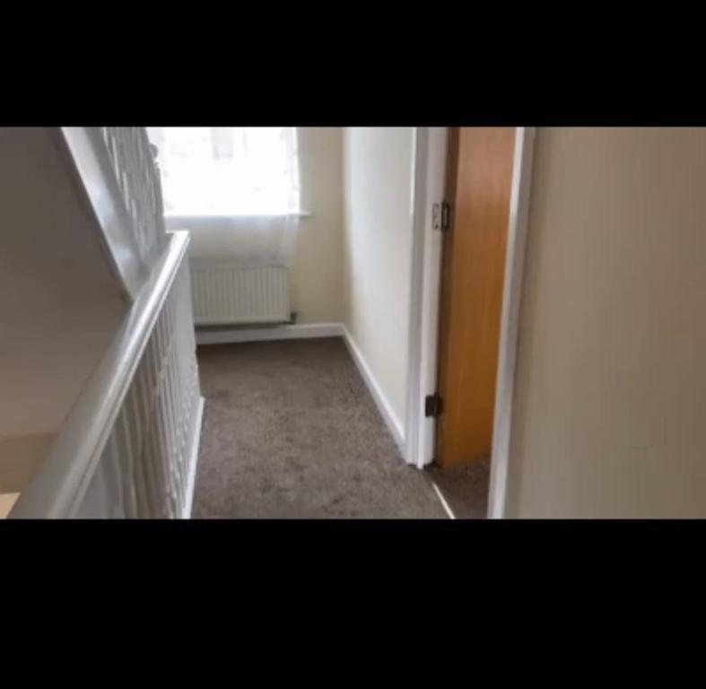 an empty hallway with a door and a window at Apartment in London in London