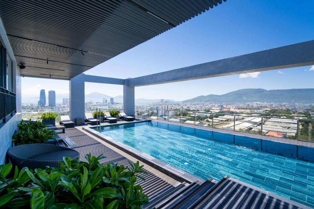 a swimming pool on the roof of a building at Luxtery Hotel & Spa in Da Nang