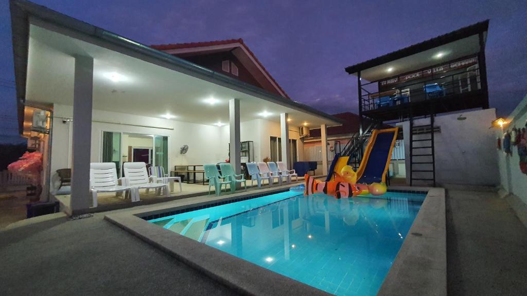 a swimming pool with a slide in a house at Family POOL VILLA CHAAM in Cha Am