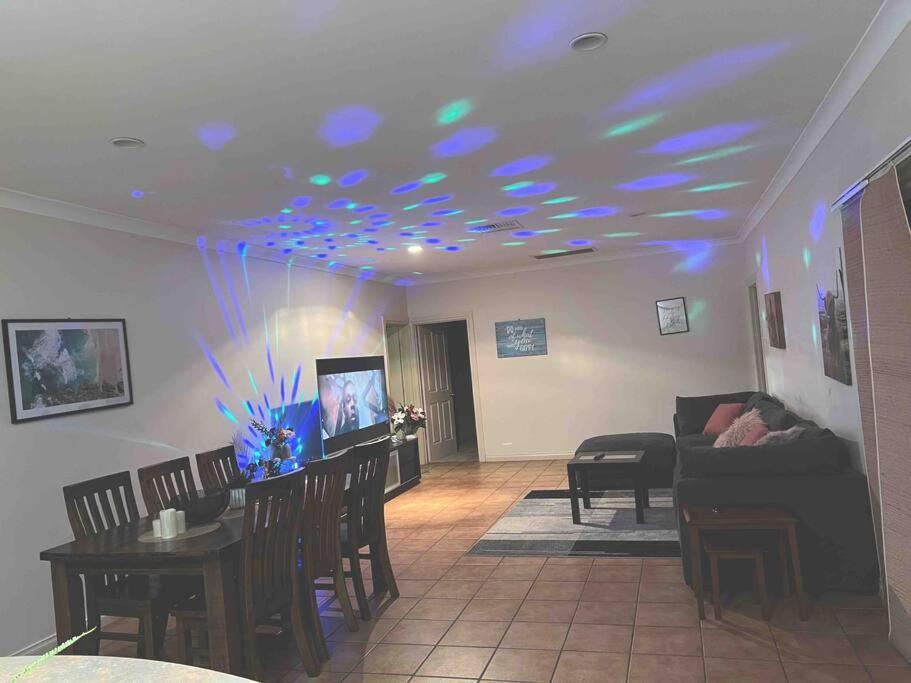 a living room with blue lights on the ceiling at Private self check in home in Alice Springs