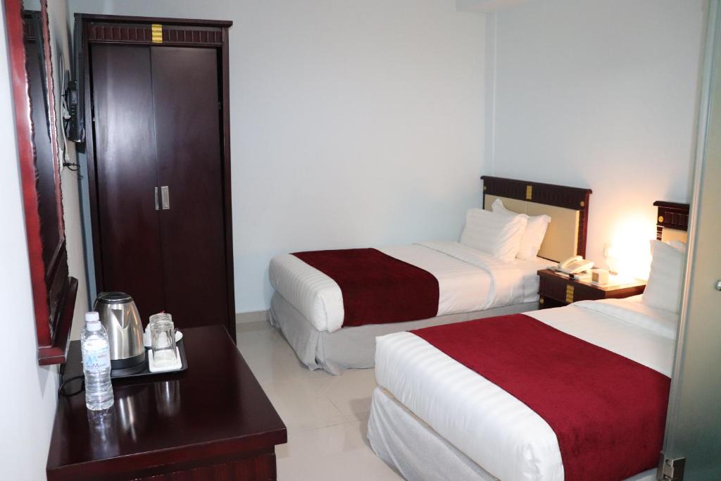 Postel nebo postele na pokoji v ubytování Hotel AL Amin