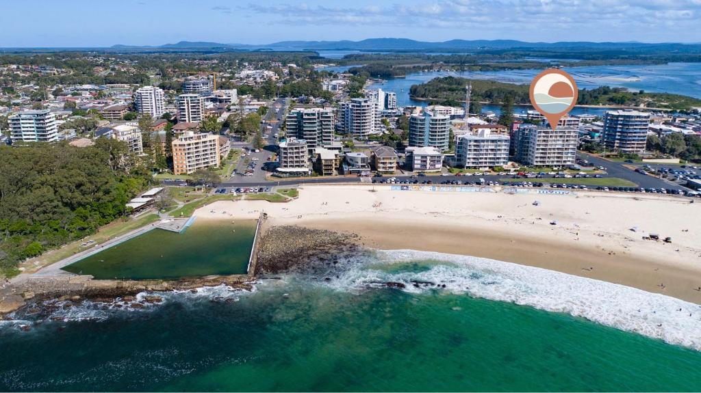 an aerial view of a beach and a city at Ebbtide Unit 33 in Forster