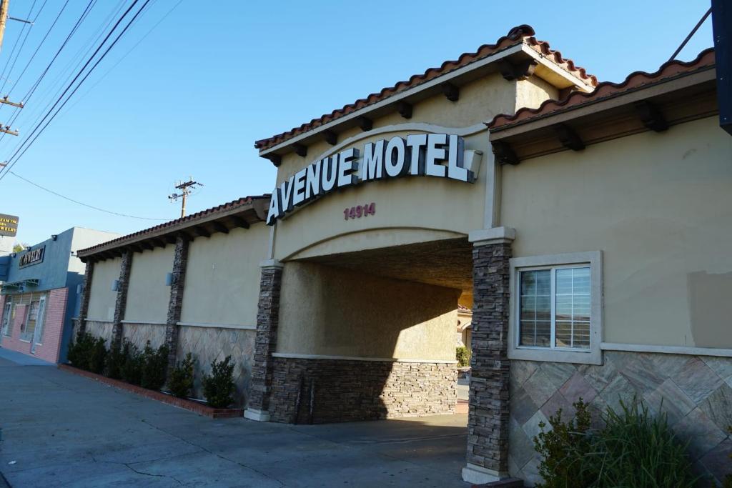 a large motel sign on the side of a building at Avenue Motel in Gardena