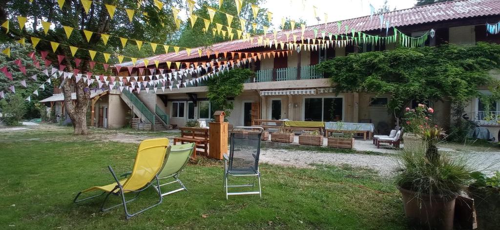 a group of chairs in the yard of a house at Gîte de Montagne Salle de Fête Thorenc in Andon