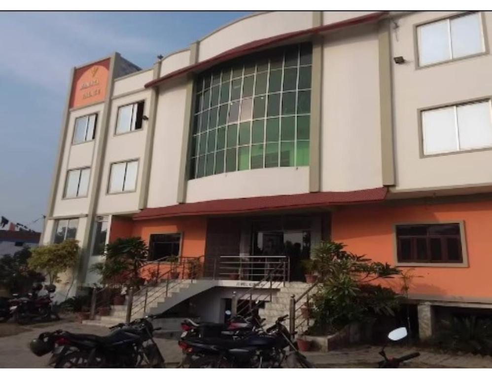 a building with motorcycles parked in front of it at Hotel Mamta Palace, Kushinagar in Kushinagar