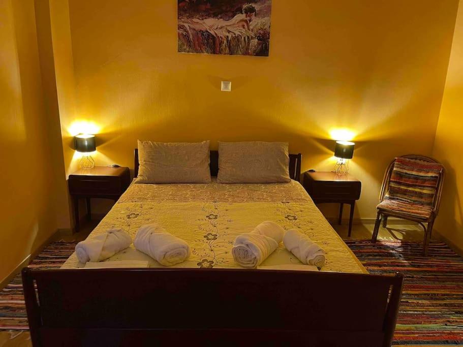 een slaapkamer met een bed met twee handdoeken erop bij Mary's Rainbow Apartment in Athene