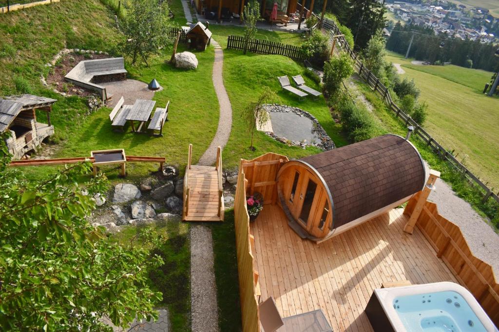 an aerial view of a backyard with a house and a pool at Ciasa Pedaga in San Vigilio Di Marebbe