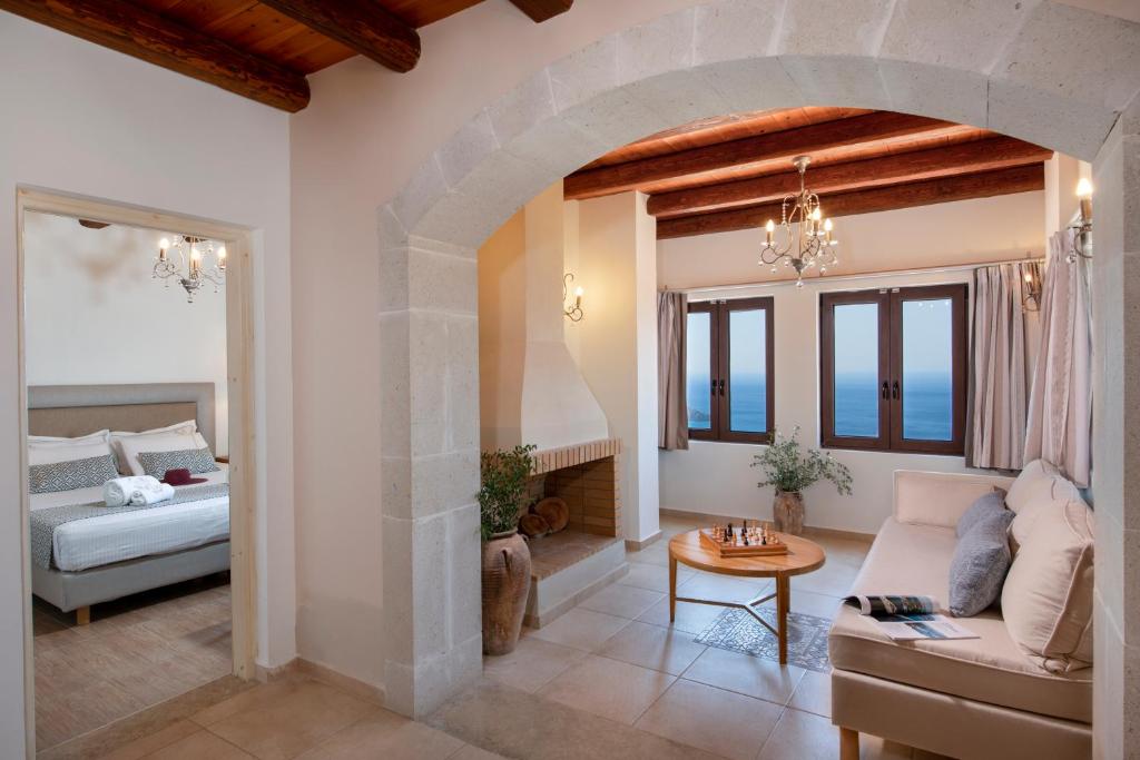 a living room with a couch and a bed and a table at Stefanos Village Hotel in Plakias