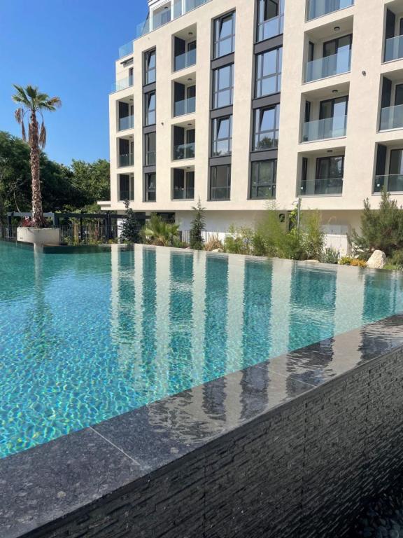 a large swimming pool in front of a building at SUNNY STUDIO AZUR in Saints Constantine and Helena