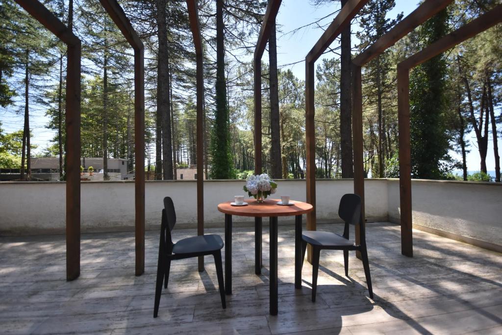 un tavolo e sedie su un patio alberato di Pine Aparthotel a Shekhvetili