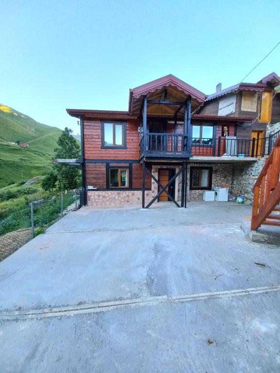 a house with a large driveway in front of it at Saklı Bahçe Suite in Uzungöl