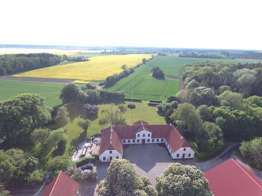 an aerial view of a large white house with trees at Værelse ved Nykøbing F. in Nykøbing Falster