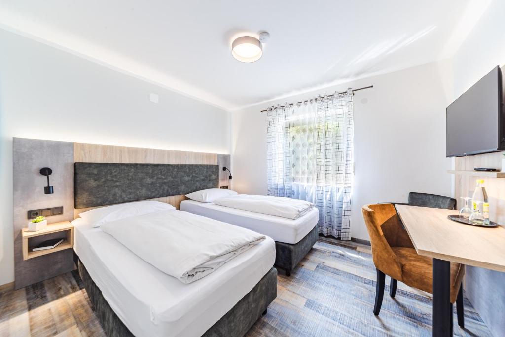 Postel nebo postele na pokoji v ubytování Hotel Franken