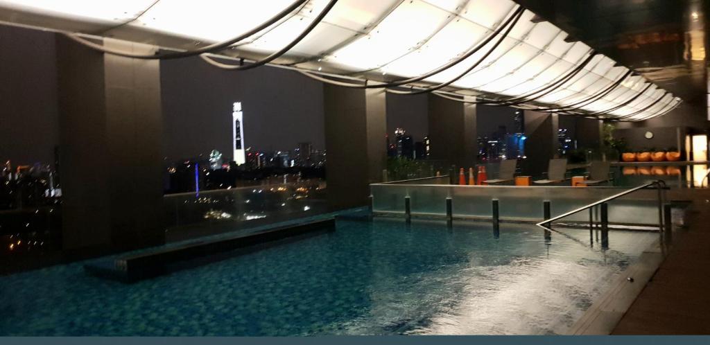 a swimming pool in a building with a city skyline at MCity Jalan Ampang in Kuala Lumpur
