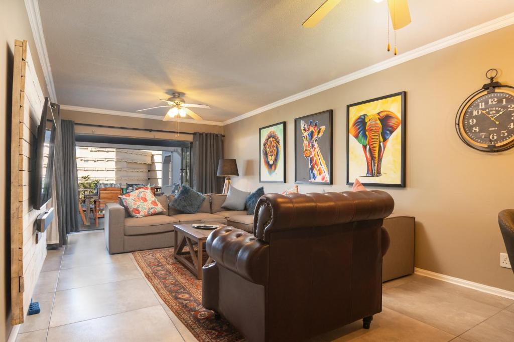 a living room with a couch and a chair at La Pirogue 14 in Ballito