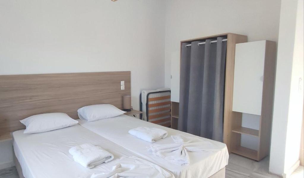 a bedroom with a bed with two white towels on it at Odysseas apartments in Agathonisi