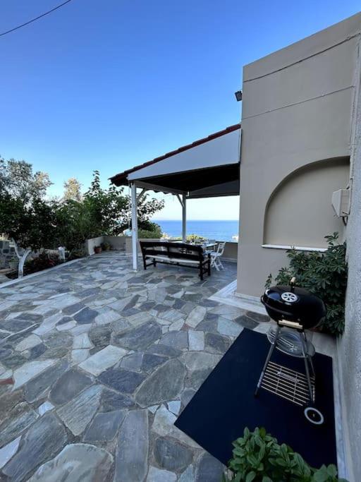 a patio with a grill and a bench on a building at Our Home in Heraklio