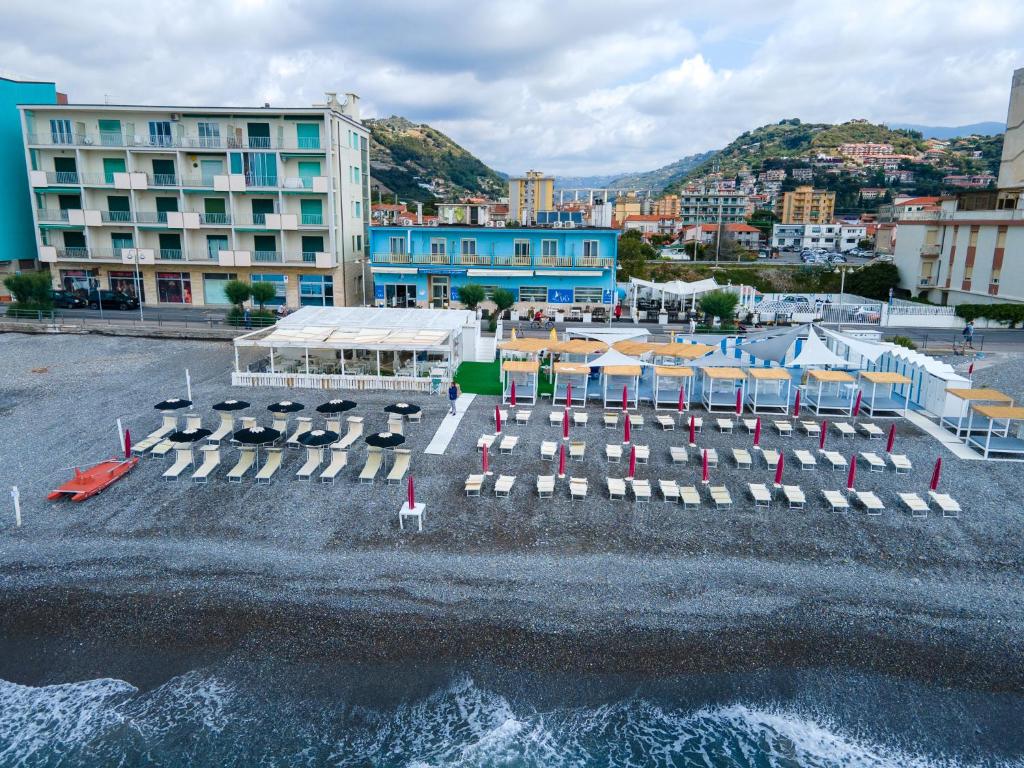 an aerial view of a beach with chairs and buildings at Hotel Piccolo Paradiso in Bordighera