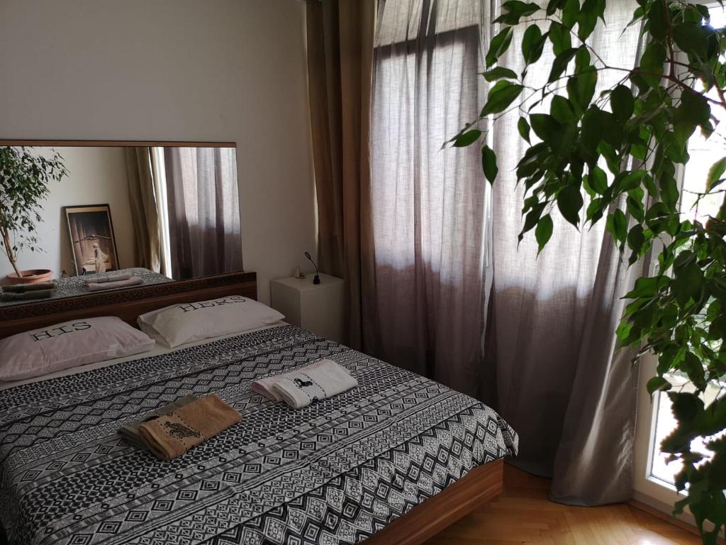a bedroom with a bed and a large mirror at TETA NEDA in Omiš